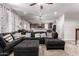 Open-concept living room seamlessly connects to the kitchen, featuring comfortable seating and ample natural light at 4068 E Devon Dr, Gilbert, AZ 85296