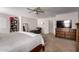 Large bedroom with a bed and sitting area, complemented by a ceiling fan at 4068 E Devon Dr, Gilbert, AZ 85296