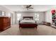 Spacious bedroom featuring a ceiling fan, large windows, and neutral-colored walls at 4068 E Devon Dr, Gilbert, AZ 85296