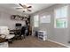 Office featuring 2 desks, 2 chairs and a ceiling fan at 4068 E Devon Dr, Gilbert, AZ 85296