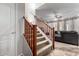 Carpeted staircase with wooden railing, leading to the upper level, with a view of the living room at 4068 E Devon Dr, Gilbert, AZ 85296