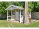 Backyard featuring a charming shed, lush greenery, and vibrant flowers at 4111 N 52Nd St, Phoenix, AZ 85018