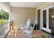 Cozy front porch with two rocking chairs and a view of the well-manicured lawn at 4111 N 52Nd St, Phoenix, AZ 85018