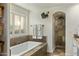 Elegant bathroom featuring a soaking tub, mosaic tile accents, and a separate shower for a spa-like experience at 4111 N 52Nd St, Phoenix, AZ 85018