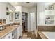 Well-lit bathroom featuring a vanity, soaking tub, and access to the bedroom for convenience at 4111 N 52Nd St, Phoenix, AZ 85018