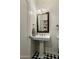 Cozy powder room features pedestal sink, checkered tile flooring, and decorative lighting for a modern touch at 4111 N 52Nd St, Phoenix, AZ 85018