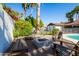 Charming backyard featuring a fire pit, bench seating, and surrounded by lush landscaping and tall palm trees at 4418 E Paradise Ln, Phoenix, AZ 85032