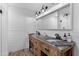 Stylish bathroom featuring a glass-enclosed shower and a rustic wood vanity with double sinks at 4418 E Paradise Ln, Phoenix, AZ 85032