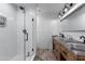 Stylish bathroom featuring a glass-enclosed shower and a rustic wood vanity with double sinks at 4418 E Paradise Ln, Phoenix, AZ 85032
