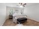 Bright bedroom featuring wood look floors, and a king-size bed at 4418 E Paradise Ln, Phoenix, AZ 85032