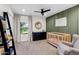 Modern Bedroom featuring a crib, changing table, rocker, and stylish decor at 4418 E Paradise Ln, Phoenix, AZ 85032