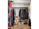 Well-organized walk-in closet with hanging clothes and shoe racks, maximizing storage space at 4418 E Paradise Ln, Phoenix, AZ 85032
