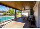 Inviting covered patio with wood ceiling, fan, comfortable seating and a view of the backyard and pool at 4418 E Paradise Ln, Phoenix, AZ 85032