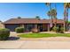 Beautiful brick home with mature landscaping, a lawn, and an American flag displayed at 4418 E Paradise Ln, Phoenix, AZ 85032