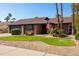 Charming single-story brick home with well-maintained landscaping and an American flag at 4418 E Paradise Ln, Phoenix, AZ 85032