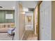 Hallway with wood-look floors leading to a Bedroom with carpet and neutral walls at 4418 E Paradise Ln, Phoenix, AZ 85032