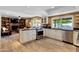 Open kitchen with stainless steel appliances and a view into the living room at 4418 E Paradise Ln, Phoenix, AZ 85032