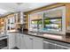 Bright kitchen with stainless steel appliances, white cabinets and granite countertop overlooking the pool at 4418 E Paradise Ln, Phoenix, AZ 85032
