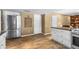 Bright kitchen with stainless steel appliances, white cabinets, granite countertop and wood-look flooring at 4418 E Paradise Ln, Phoenix, AZ 85032