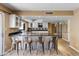 Open floorplan kitchen with stainless steel appliances, white cabinets and breakfast bar at 4418 E Paradise Ln, Phoenix, AZ 85032