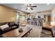Open floorplan living room connecting to kitchen with breakfast bar and view of backyard at 4418 E Paradise Ln, Phoenix, AZ 85032