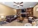Comfortable living room featuring a brick fireplace and built-in bookshelves, perfect for entertaining at 4418 E Paradise Ln, Phoenix, AZ 85032