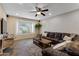 Cozy living room with a leather sectional, wooden coffee table, and natural light at 4418 E Paradise Ln, Phoenix, AZ 85032