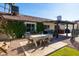 Charming patio area set for dining, enhanced with string lights and lush greenery, perfect for outdoor gatherings at 4418 E Paradise Ln, Phoenix, AZ 85032