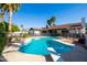 Beautiful pool featuring a diving board, pool furniture, a perimeter fence, and mature landscaping at 4418 E Paradise Ln, Phoenix, AZ 85032