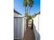 Side yard access to the backyard, fenced, features a storage shed and gravel walkway at 4418 E Paradise Ln, Phoenix, AZ 85032