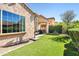 Inviting backyard featuring an outdoor patio and manicured artificial lawn, ideal for relaxing or entertaining at 4535 E Navigator Ln, Phoenix, AZ 85050