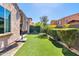Well-maintained backyard with lush artificial turf and privacy hedges, perfect for outdoor enjoyment at 4535 E Navigator Ln, Phoenix, AZ 85050