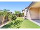 Backyard featuring artificial grass, shrubs, and a palm tree at 4535 E Navigator Ln, Phoenix, AZ 85050