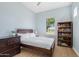 Bedroom features a bed, side table, dresser, bookcase and a window at 4535 E Navigator Ln, Phoenix, AZ 85050