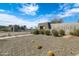 Community entrance featuring a monument sign and stone accents with desert landscaping on a sunny day at 4535 E Navigator Ln, Phoenix, AZ 85050