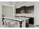 Kitchen island featuring marble countertop with seating and modern appliances at 4535 E Navigator Ln, Phoenix, AZ 85050