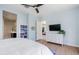 Relaxing primary bedroom featuring a ceiling fan, light blue walls, and a convenient en-suite bathroom creates a private haven at 4535 E Navigator Ln, Phoenix, AZ 85050