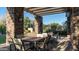 Outdoor dining area with a pergola, stone columns, and comfortable seating for relaxing or entertaining at 4535 E Navigator Ln, Phoenix, AZ 85050
