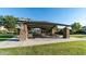 Community park pavilion with stone pillars, covered picnic tables, and playground in a well-maintained grassy area at 4535 E Navigator Ln, Phoenix, AZ 85050