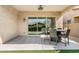 Covered patio with ceiling fan, outdoor dining set, and sliding glass doors leading to backyard at 4535 E Navigator Ln, Phoenix, AZ 85050