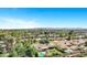 Stunning aerial shot captures a picturesque community with tree-lined streets and inviting homes, many boasting private pools, all under a clear sky at 4634 E Wilshire Dr, Phoenix, AZ 85008