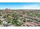 Bird's-eye view of a peaceful neighborhood with verdant trees, tidy homes, and sparkling pools under a bright blue sky at 4634 E Wilshire Dr, Phoenix, AZ 85008