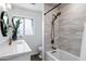 Bright bathroom featuring modern fixtures, a stylish vanity, and a separate shower and tub at 4634 E Wilshire Dr, Phoenix, AZ 85008