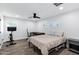 Bedroom with wood-look flooring, a workspace, and a bed with neutral bedding at 4634 E Wilshire Dr, Phoenix, AZ 85008
