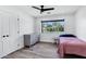 Cozy bedroom with wood-look flooring, a dresser, and a bright window overlooking the yard at 4634 E Wilshire Dr, Phoenix, AZ 85008