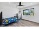 Light and airy bedroom with wood-look flooring, a dresser, and a large window offering natural light at 4634 E Wilshire Dr, Phoenix, AZ 85008