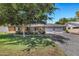 Charming single-story home featuring a brick exterior, a manicured front yard, and a spacious driveway with a three-car garage at 4634 E Wilshire Dr, Phoenix, AZ 85008