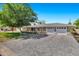 Charming single-story home featuring a brick exterior, a large front yard, and a spacious driveway with a three-car garage at 4634 E Wilshire Dr, Phoenix, AZ 85008