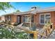 Inviting front porch with comfortable seating, surrounded by lush landscaping and a charming brick facade at 4634 E Wilshire Dr, Phoenix, AZ 85008