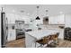 Bright kitchen with white cabinets, stainless steel appliances, and a large quartz island at 4634 E Wilshire Dr, Phoenix, AZ 85008